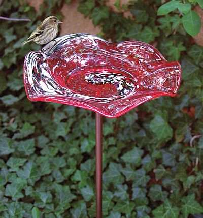 This unique solid glass bird bath is sure to attract a lot of attention.